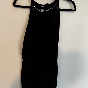 Black jumpsuit with a silver necklace detail very flattering shape